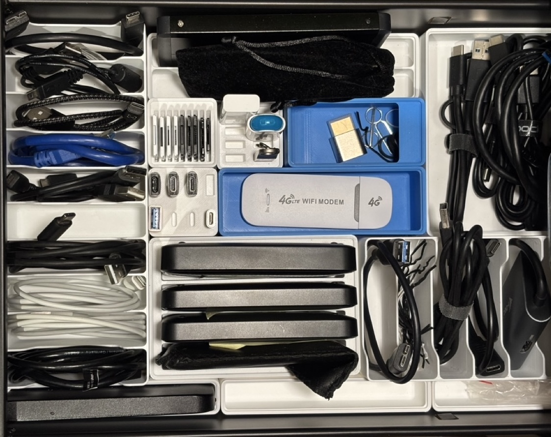 Drawer with electronic devices sorted in Gridfinity layout